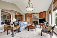 Classic living room interior with large windows arches and vaulted ceiling in luxurious house. Northwest USA